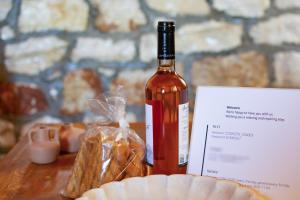 a bottle of wine sitting on top of a table at ORIZON LIVING Lefkada in Vavkerí