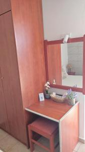 a dressing table with a stool and a mirror at Villa Christina Sea Side B in Hanioti