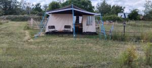a tent in the middle of a field at DDR Klapfix Camptourist in Sandau +4 photos
