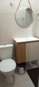 a bathroom with a toilet and a sink and a mirror at Espaço Jk in Diamantina +24 photos