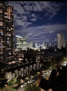 a city skyline at night with tall buildings at Luxury Heart of the city in Surrey