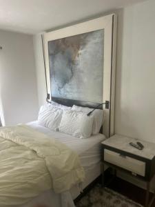 a bedroom with a bed and a painting on the wall at QueenRoom1 in Ellenwood