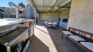 a patio with a table and a table and chairs at Casa vacacional El Arroyo in Ferreras de Arriba