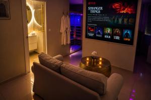 a living room with a couch and a table at Eaux Spa in Rouen