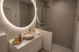 a bathroom with a sink and a mirror at Eaux Spa in Rouen