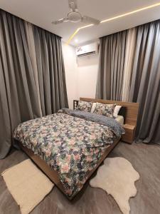 a bedroom with a large bed with curtains and a bedspread at La Villa K - 1 Studio in Lomé