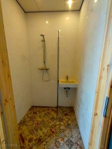 a bathroom with a shower and a sink at DDR Klapfix Camptourist in Sandau