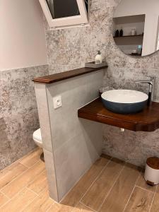 a bathroom with a sink and a mirror at La chambre des clefs in Ranville +7 photos