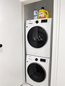 a washing machine and a washer in a closet at Modern suite in Surrey +6 photos