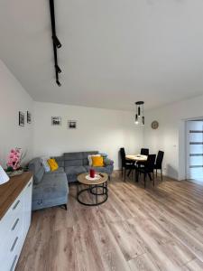 a living room with a couch and a table at NOVA Apartament Podgórze in Wałbrzych +13 photos