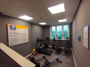 a gym with several tread machines in a room at DDR Klapfix Camptourist in Sandau