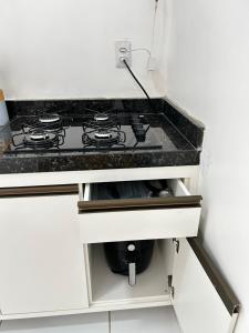 a kitchen counter with a stove top in a kitchen at Chalés Areias in Barreirinhas