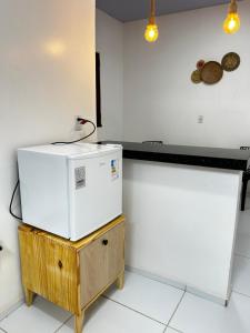 a microwave sitting on a table in a kitchen at Chalés Areias in Barreirinhas