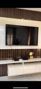 a large flat screen tv on a wall at Oak Serviced Apartment-New Bodija in Ibadan
