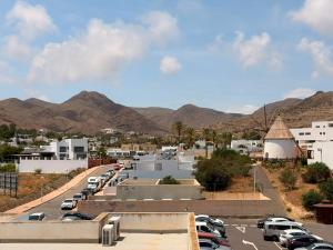 a parking lot with cars parked in front of mountains at casArena 1 in Las Negras