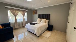 a bedroom with a bed and a large window at Bella Vista in Edenvale