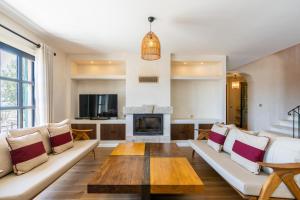 a living room with a couch and a fireplace at Viento Villa in Çeşme