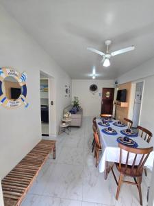 a dining room and living room with a table and chairs at Praia Morro Katia apartamentos - Edificio Franklin Storck in Guarapari +11 photos