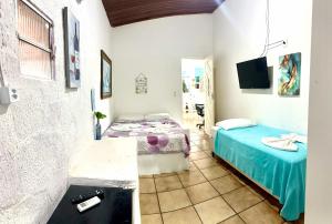 a room with a bed and a tv in it at Pousada Brasil Natal in Natal +69 photos