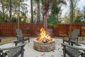 two chairs and a fire pit in a yard at The Summer House - Private Pool Firepit in Jacksonville