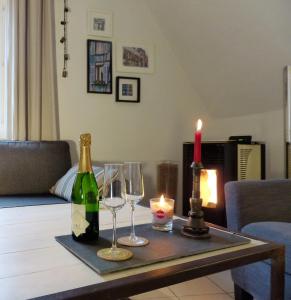 a table with two wine glasses and a candle at La Venise bleue in Colmar +8 photos