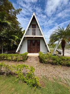 a small white house with a large door at El Rincon De Lupe in San Carlos