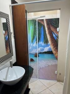 a bathroom with a window with a view of the beach at Na Boca do Jacaré in Caraguatatuba +68 photos