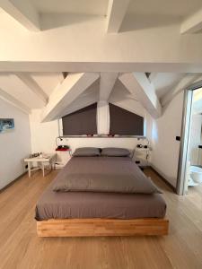 a bedroom with a large bed in a room at Casa Cocci in Aosta
