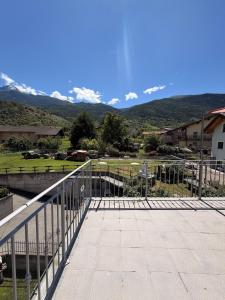 a balcony with a fence and mountains in the background at Casa Cocci in Aosta