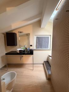 a bathroom with a sink and a bath tub at Casa Cocci in Aosta +35 photos