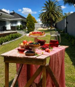 a picnic table with food and wine on it at Bella Vista in Edenvale