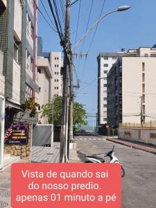 a motorcycle parked on the side of a street at Praia Morro Katia apartamentos - Edificio Franklin Storck in Guarapari