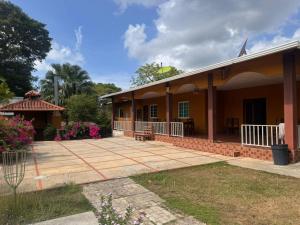 a house with a patio in front of it at El Rincon De Lupe in San Carlos