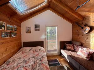 a bedroom with a bed and a window at Vacation Home Pliva in Šipovo