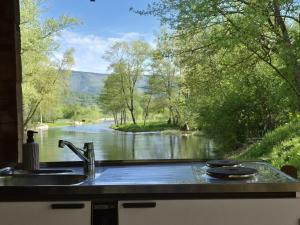 a kitchen sink with a view of a river at Vacation Home Pliva in Šipovo