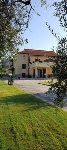 a large building with a grassy field in front of it at La casa di Nonna Anna in Castellabate