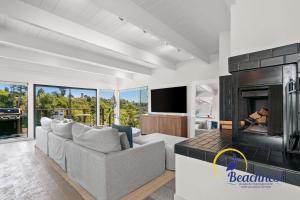 a living room with a couch and a fireplace at Coastal Treehouse in Aptos