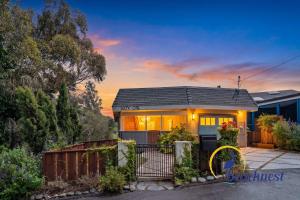 a house with a fence in front of it at Coastal Treehouse in Aptos