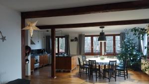 a kitchen and dining room with a table and chairs at Dom Przy Lesie in Wisła
