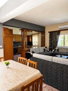 a living room with a table and a couch at Vila New Ksamil in Ksamil