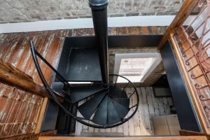 a spiral staircase with a black metal sculpture at Brick house in Savannah
