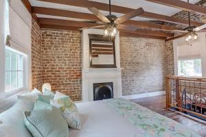 a bedroom with a bed and a brick wall at Brick house in Savannah