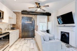 a living room with a ceiling fan and a fireplace at Brick house in Savannah +32 photos