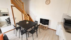 a dining room with a black table and chairs at Mons 21C in Mons