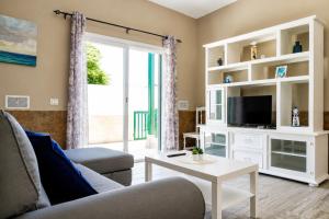 a living room with a couch and a tv at La Casita del Sur, Abades in Abades