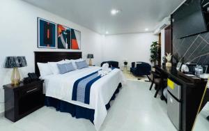 a bedroom with a large bed and a desk at Hotel Fénix in Santa Rosa de Copán