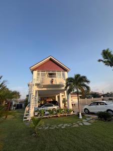 a house with cars parked in front of it at Nyaniba Villa in Accra
