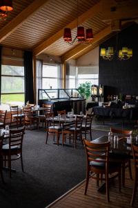 a restaurant with tables and chairs and a pool table at Ørnes Hotell in Ørnes +18 photos