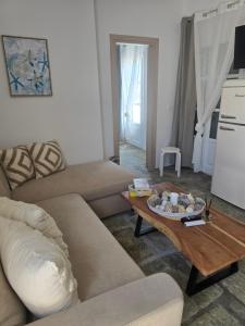a living room with a couch and a coffee table at Utopia Kythnos Althea in Kithnos