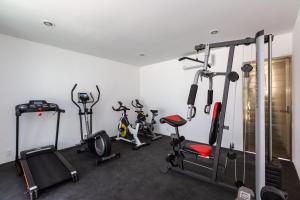 a gym with several exercise bikes in a room at Paraíso maya apartaments in Playa del Carmen